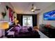 Bedroom with a ceiling fan, mounted TV, and a private balcony overlooking the lake at 1010 Strathmore Dr, Orlando, FL 32806