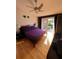 Cozy main bedroom featuring a balcony with scenic views, hardwood floors, and a ceiling fan at 1010 Strathmore Dr, Orlando, FL 32806