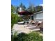 Inviting patio with lounge chairs, an umbrella, and lush landscaping perfect for outdoor relaxation at 1010 Strathmore Dr, Orlando, FL 32806