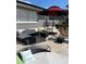 Image of the outdoor patio with furniture, a shade umbrella, and a stone floor at 1010 Strathmore Dr, Orlando, FL 32806