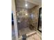 Modern walk-in shower featuring stone tile, a glass door, and a built-in bench at 1010 Strathmore Dr, Orlando, FL 32806