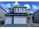 Two-story home with a two-car garage and a gray exterior, featuring white trim and a well-manicured lawn at 1181 Basalt Ln, Sanford, FL 32771