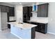 Bright kitchen featuring a center island, dark cabinets, stainless appliances, and light countertops at 1181 Basalt Ln, Sanford, FL 32771