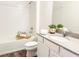 Clean bathroom with a shower-tub combination, wood-look flooring, and vanity with quartz countertop at 886 Grazie Loop, Davenport, FL 33837