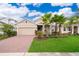 Two-story home with a two-car garage and landscaped lawn at 886 Grazie Loop, Davenport, FL 33837