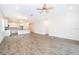 Open living room with tile floors and kitchen view at 886 Grazie Loop, Davenport, FL 33837