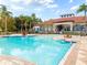 Community pool with lounge chairs and a surrounding patio at 886 Grazie Loop, Davenport, FL 33837