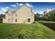 Two-story yellow house with green lawn and water view at 5009 Laguna Bay Cir # 41, Kissimmee, FL 34746