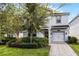 Two-story house with gray exterior, two-car garage, and landscaping at 1638 Moon Valley Dr, Davenport, FL 33896
