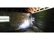 Unfinished basement with wooden garage door and window at 3408 Lewis Ct, Orlando, FL 32805