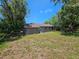 Back exterior view of the house with a large backyard at 3408 Lewis Ct, Orlando, FL 32805