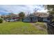 House exterior showcasing a walkway to the front door and a spacious yard at 3408 Lewis Ct, Orlando, FL 32805