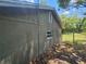 Side view of house with stucco siding and a small window at 3408 Lewis Ct, Orlando, FL 32805