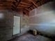 Unfinished garage with exposed block walls and concrete floor at 3408 Lewis Ct, Orlando, FL 32805
