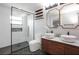 Contemporary bathroom with dual sinks, modern vanity, glass shower, and black hexagon tile at 10544 Wyndcliff Dr, Orlando, FL 32817