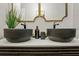 Luxurious bathroom featuring dual dark vessel sinks, modern fixtures, and a sleek vanity at 10544 Wyndcliff Dr, Orlando, FL 32817