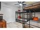 Cozy bedroom features a ceiling fan, whitewashed wood floors, and two triple bunk beds at 10544 Wyndcliff Dr, Orlando, FL 32817