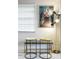 Modern sitting area showcases stylish stools, a chic lamp, and vibrant wall art at 10544 Wyndcliff Dr, Orlando, FL 32817