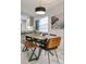 Bright dining room boasting a modern table and seating with a view into the contemporary kitchen at 10544 Wyndcliff Dr, Orlando, FL 32817