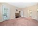 Bright bedroom featuring a fireplace, access to an outdoor patio, and neutral carpeting at 1223 Country Club Oaks Cir, Orlando, FL 32804