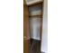 Bedroom closet with hanging rod and laminate flooring at 2661 Waccassa St, Geneva, FL 32732
