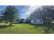 Charming home with a spacious front yard and shed surrounded by mature trees, offering a serene setting at 2661 Waccassa St, Geneva, FL 32732