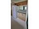 Kitchen area with stainless steel refrigerator and wooden cabinets with white countertop at 2661 Waccassa St, Geneva, FL 32732