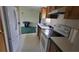 A view into the kitchen area of the home with white appliances and wood cabinets at 2661 Waccassa St, Geneva, FL 32732