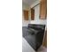 Functional laundry area boasts a sleek, dark washer and dryer set with convenient overhead cabinet storage at 2661 Waccassa St, Geneva, FL 32732