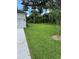 Spacious, green backyard featuring well-maintained lawn and new landscaping with an attached garage at 282 Kimble Ave, Oviedo, FL 32765