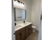 Modern bathroom with double sinks, a large mirror, and sleek fixtures at 282 Kimble Ave, Oviedo, FL 32765
