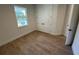 Bright bedroom features wood-look tile flooring, a window, and closet with double doors at 282 Kimble Ave, Oviedo, FL 32765