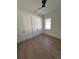 This bedroom features wood-look tile floors, a black ceiling fan, and a window for lots of natural light at 282 Kimble Ave, Oviedo, FL 32765
