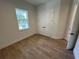 Bright bedroom features wood-look tile flooring, a window, and closet with double doors at 282 Kimble Ave, Oviedo, FL 32765