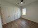 Bedroom with wood-look tile flooring and white trim at 282 Kimble Ave, Oviedo, FL 32765