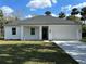 Charming single-story home featuring a manicured lawn and attached two-car garage at 282 Kimble Ave, Oviedo, FL 32765