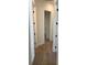 Hallway features wood-look tile flooring, white walls, and black door hardware at 282 Kimble Ave, Oviedo, FL 32765