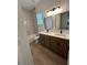 Bathroom with dual sinks, white countertops, and a tub with white subway tile at 292 Kimble Ave, Oviedo, FL 32765