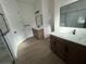 Modern bathroom featuring dual vanities, decorative mirrors, and tile flooring at 292 Kimble Ave, Oviedo, FL 32765