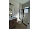 Modern bathroom featuring a glass-enclosed shower, sleek vanity, and contemporary fixtures at 292 Kimble Ave, Oviedo, FL 32765