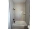 Bathroom featuring a white tub with white subway tile and black fixtures at 292 Kimble Ave, Oviedo, FL 32765