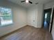 Bright bedroom with a ceiling fan, wood-look tile, and a view of the backyard at 292 Kimble Ave, Oviedo, FL 32765