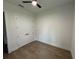 Bedroom with a ceiling fan, wood-look tile, and a closet with white doors at 292 Kimble Ave, Oviedo, FL 32765