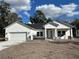 White two-story house with a two-car garage and stone accents at 292 Kimble Ave, Oviedo, FL 32765