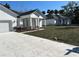 Modern exterior featuring white siding, black roof, and well-manicured landscaping and driveways at 292 Kimble Ave, Oviedo, FL 32765