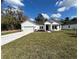 Beautiful white home with a two-car garage and a well-manicured lawn at 292 Kimble Ave, Oviedo, FL 32765
