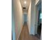 Hallway with wood-style tile flooring and neutral paint leads to other rooms in the home at 292 Kimble Ave, Oviedo, FL 32765