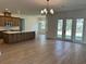 Open kitchen with stainless steel appliances, large island, and tile floors that flow into a large open space at 292 Kimble Ave, Oviedo, FL 32765