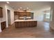 Bright, open kitchen with an island, stainless steel appliances, custom cabinetry, and tile flooring throughout at 292 Kimble Ave, Oviedo, FL 32765