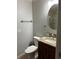Cozy powder room featuring a decorative sink with granite counter and a round mirror at 3336 Edgecliffe Dr, Orlando, FL 32806